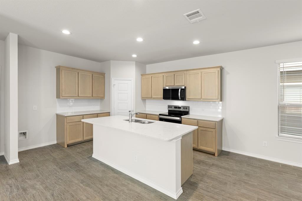 1713 Teton River Drive Blue Ridge, TX 75424 - Photo 10 of 29 a kitchen with a stove a sink and a microwave