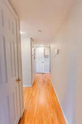 a view of hallway with wooden floor