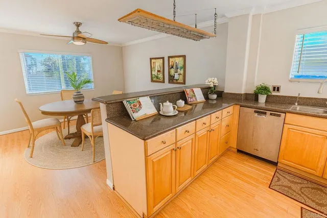 a kitchen with stainless steel appliances granite countertop a sink and a refrigerator