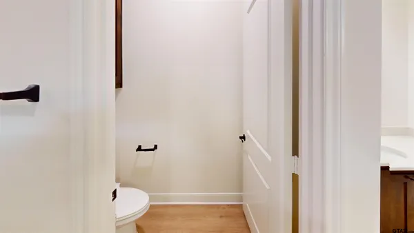 a bathroom with a granite countertop shower and a toilet