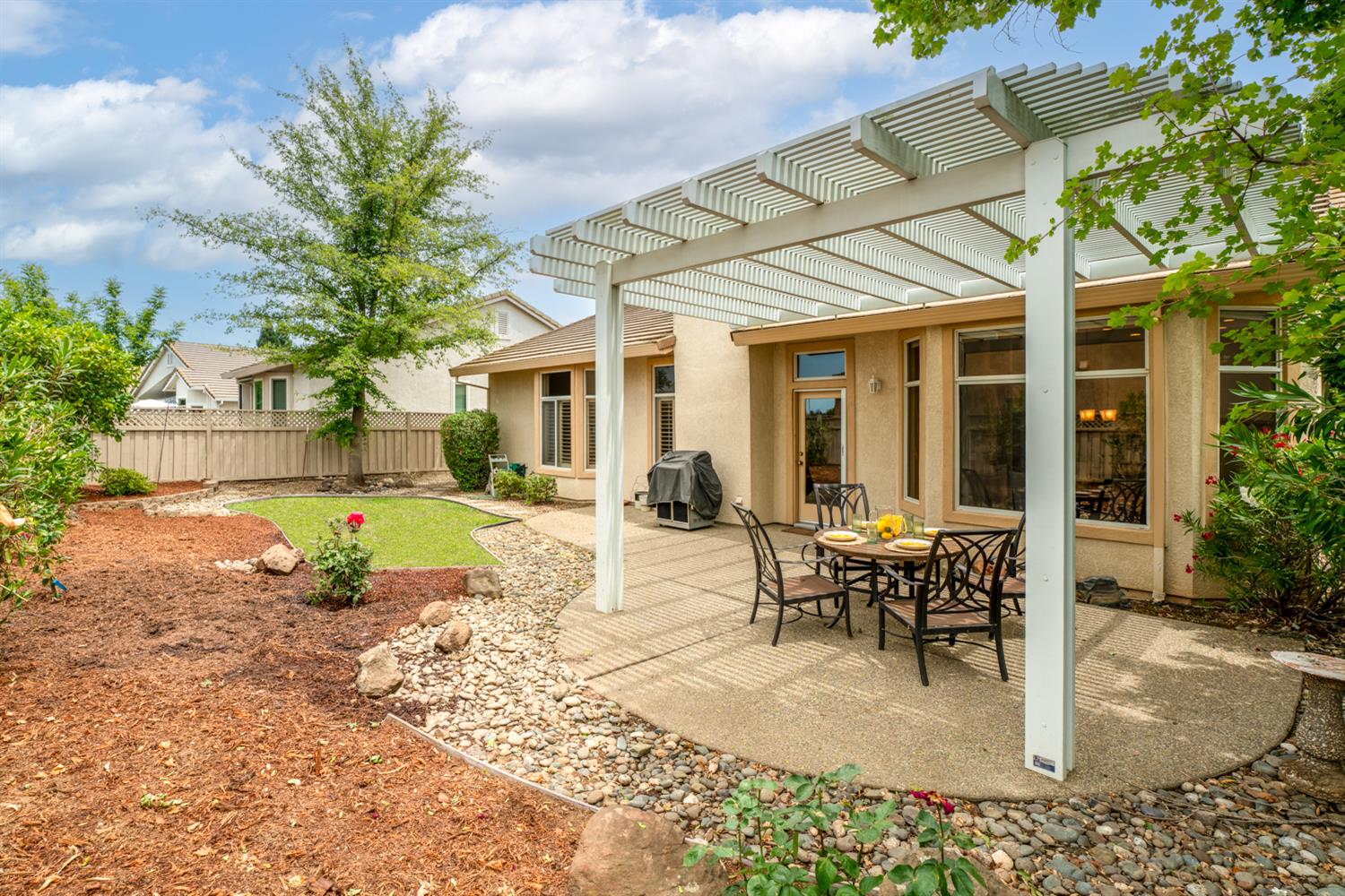 4081 Rose Creek Road Roseville, CA 95747 - Photo 42 of 52 a view of a house with backyard porch and sitting area