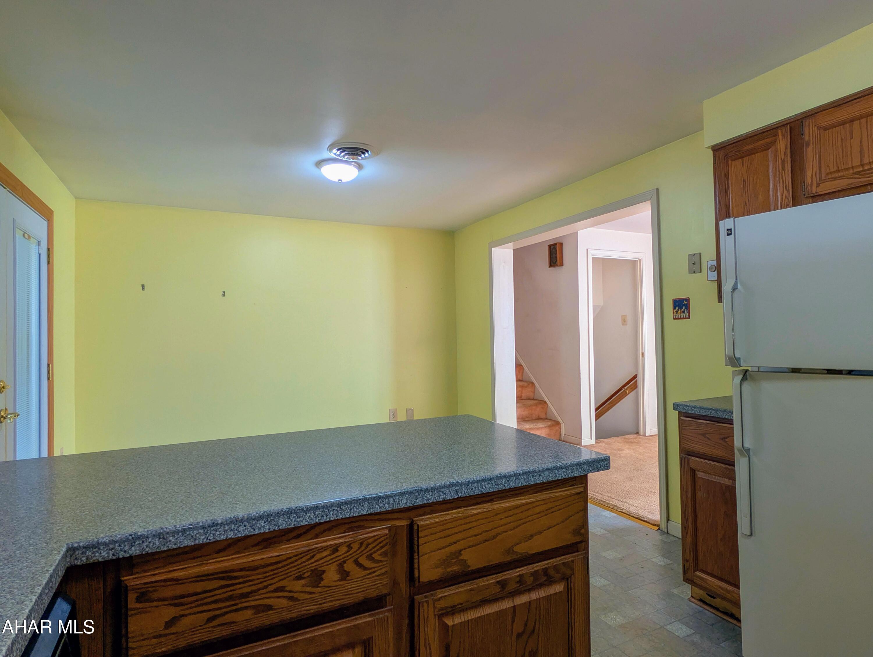 147 Pine Street Hyndman, PA 15545 - Photo 10 of 44 a view of room with refrigerator and wooden floor