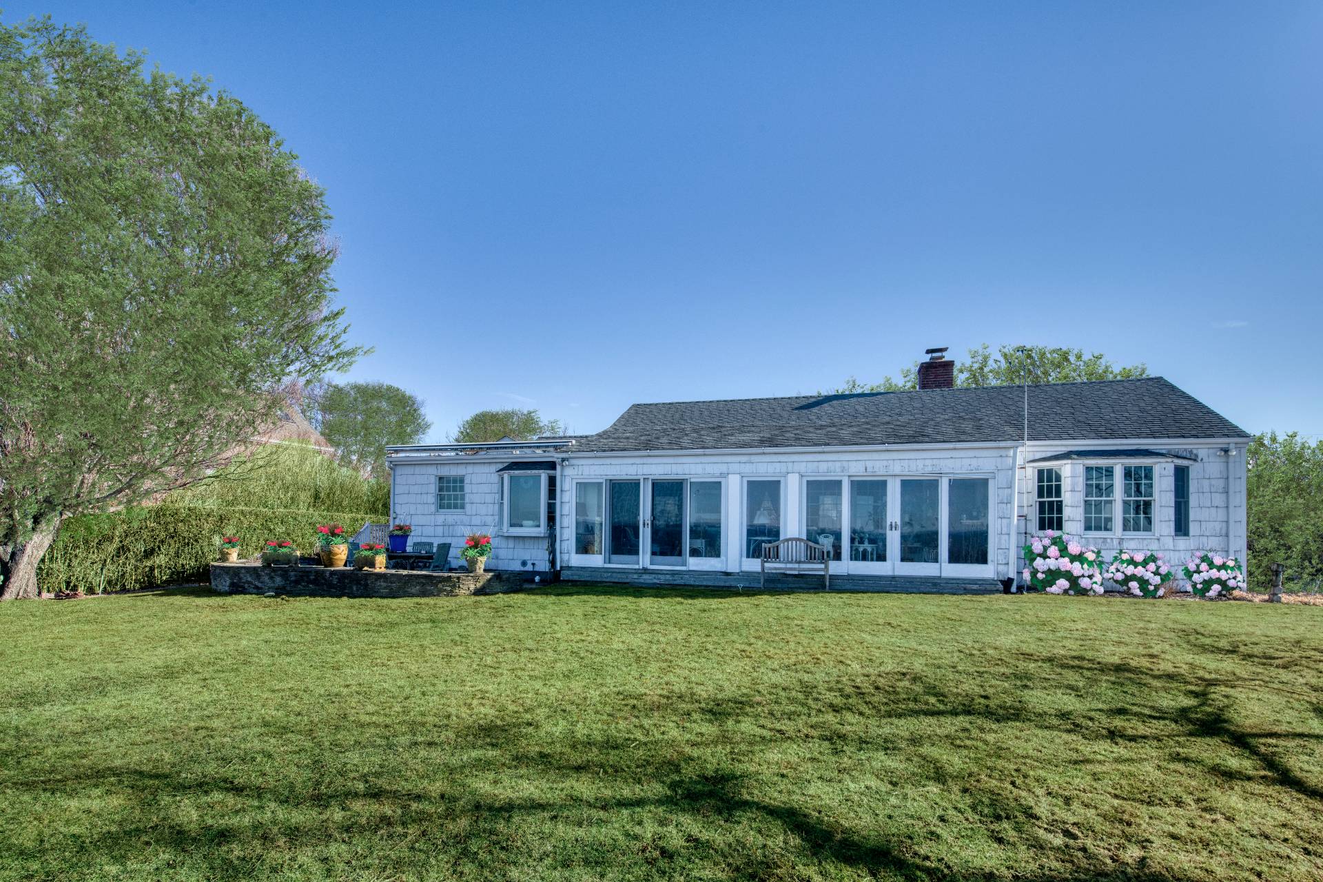 335 Sound View Road Orient, NY 11957 - Photo 3 of 22 a front view of a house with a yard table and chairs