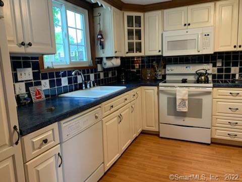 22 Fairview Avenue Madison, CT 06443 - Photo 14 of 31 a kitchen with granite countertop white cabinets and white appliances