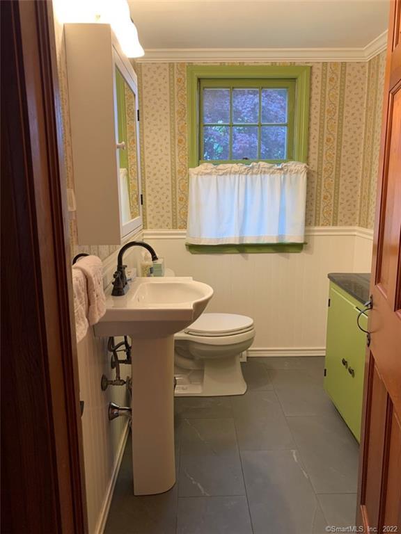 22 Fairview Avenue Madison, CT 06443 - Photo 22 of 31 a bathroom with a sink a toilet and a window