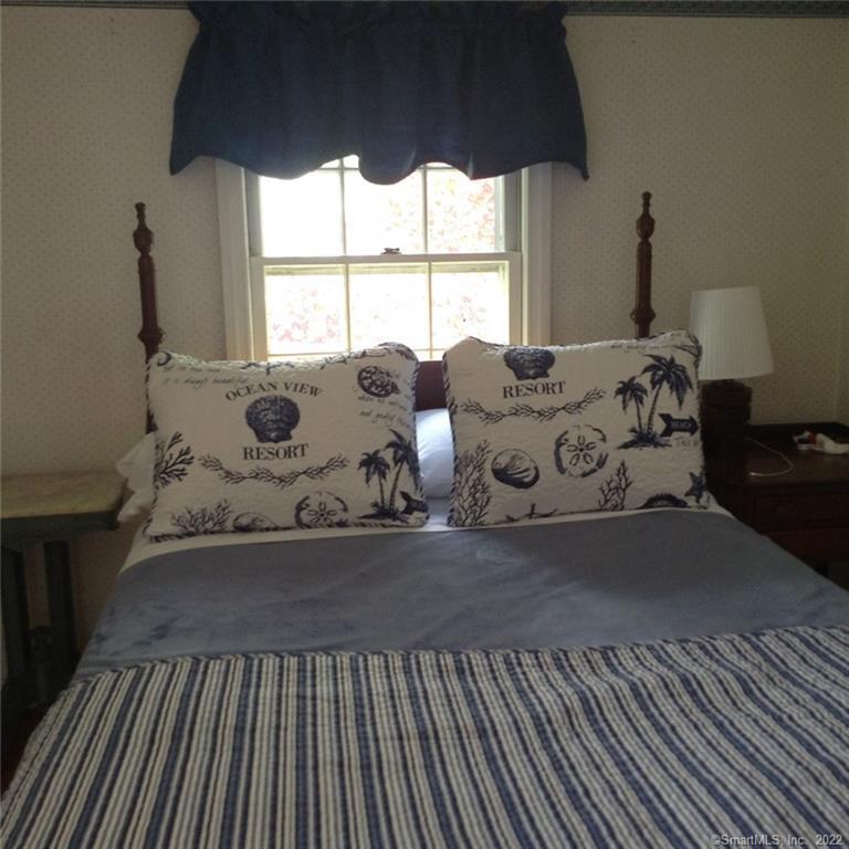22 Fairview Avenue Madison, CT 06443 - Photo 23 of 31 a bed sitting in a bedroom next to a window