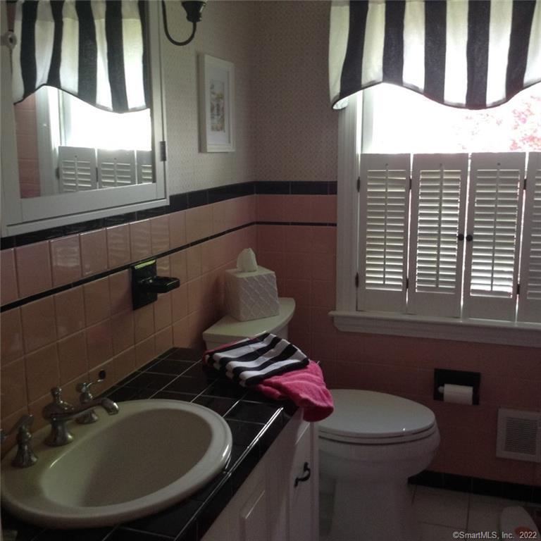 22 Fairview Avenue Madison, CT 06443 - Photo 25 of 31 a bathroom with a sink a toilet and a mirror