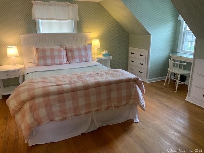 22 Fairview Avenue Madison, CT 06443 - Photo 28 of 31 a bedroom with a bed and wooden floor