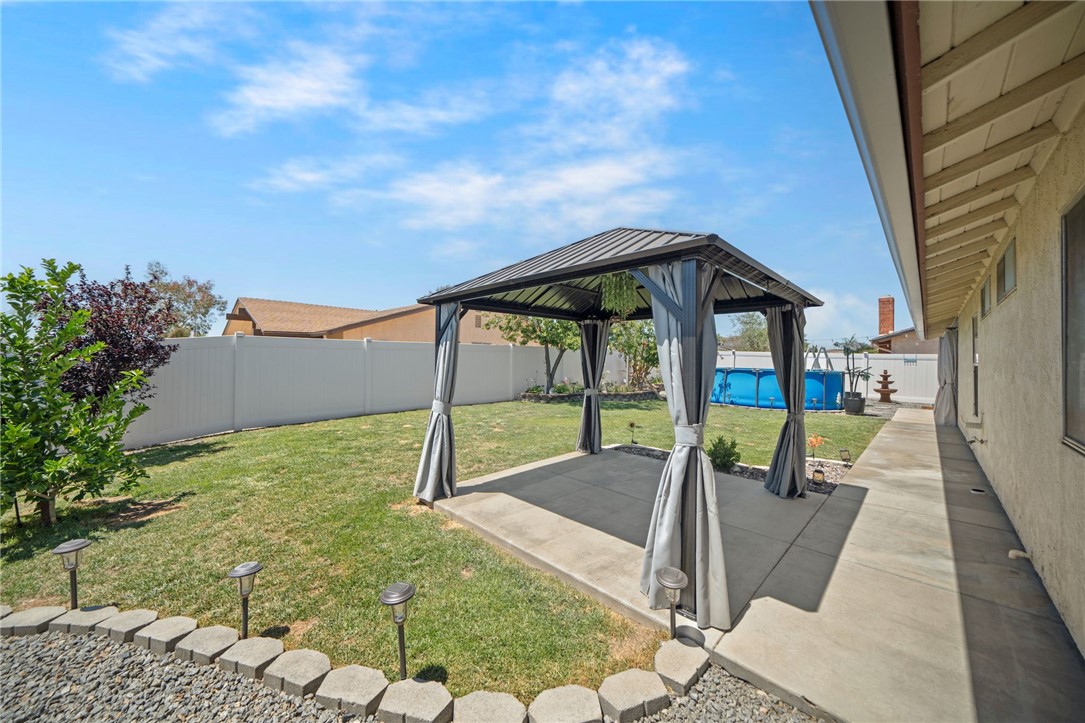 27879 Foxfire Street Menifee, CA 92586 - Photo 36 of 36 a view of an house with backyard porch and furniture