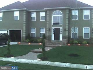 154 Quiet Road Sicklerville, NJ 08081 - Photo 2 of 6 a front view of a house with a garden