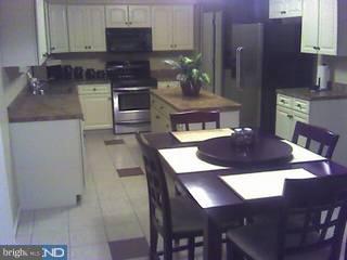 154 Quiet Road Sicklerville, NJ 08081 - Photo 6 of 6 a kitchen with a wooden table and chairs