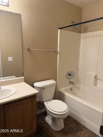 a white toilet sitting next to a bath tub