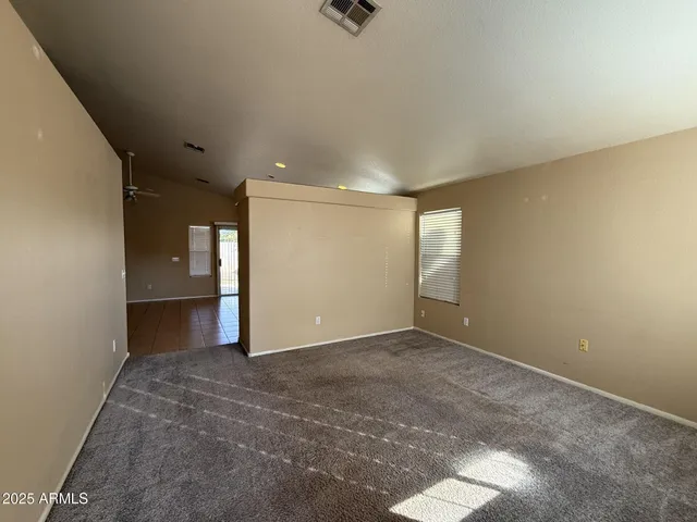 an empty room with windows and cabinet