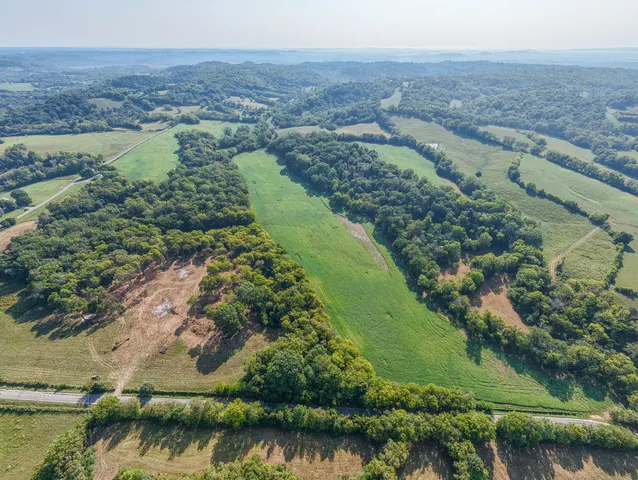 an aerial view of a houses with outdoor space and a lake view