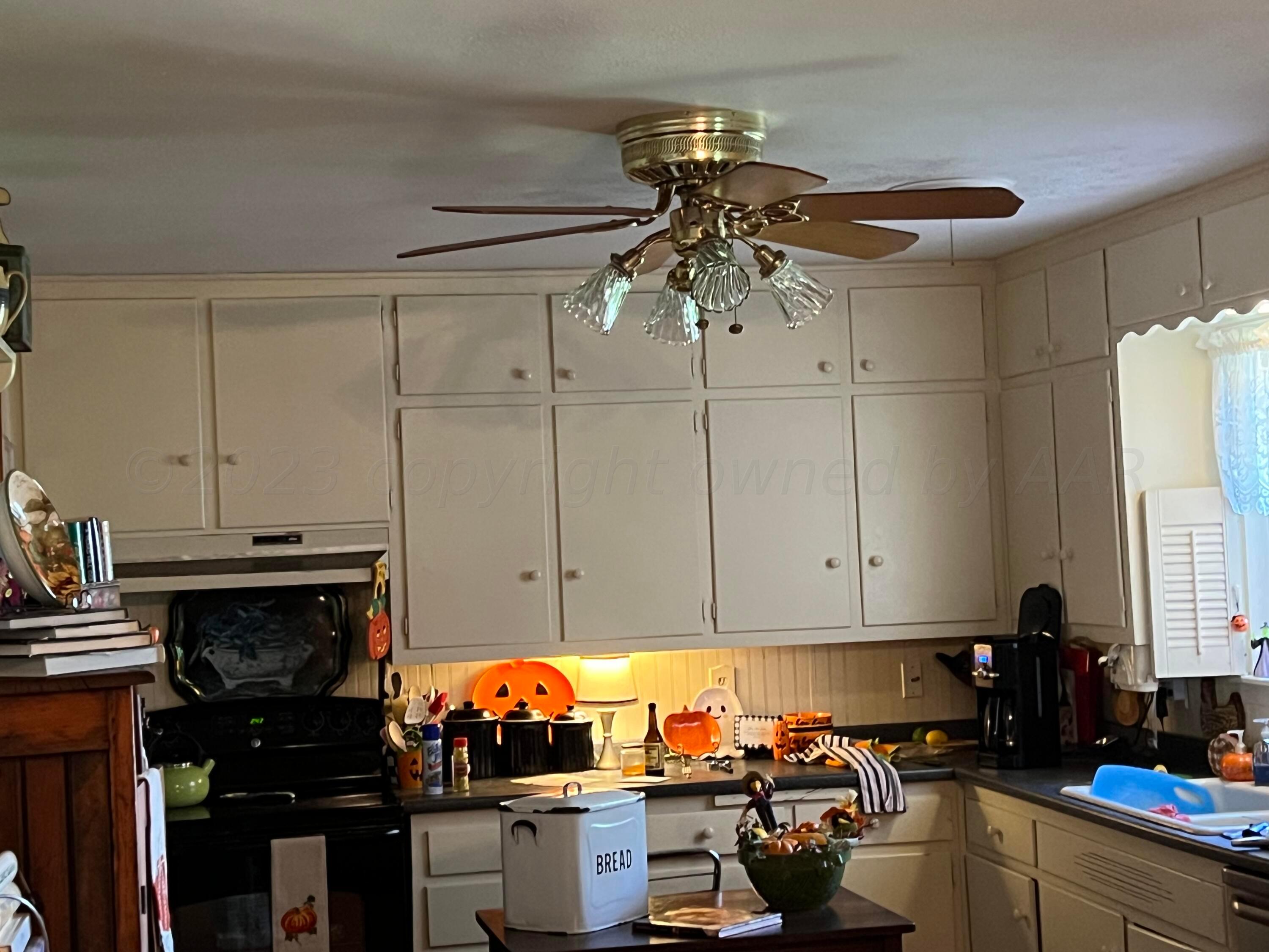 1505 Pellinore Street Borger, TX 79007 - Photo 11 of 73 a kitchen with stainless steel appliances a stove a refrigerator and cabinets