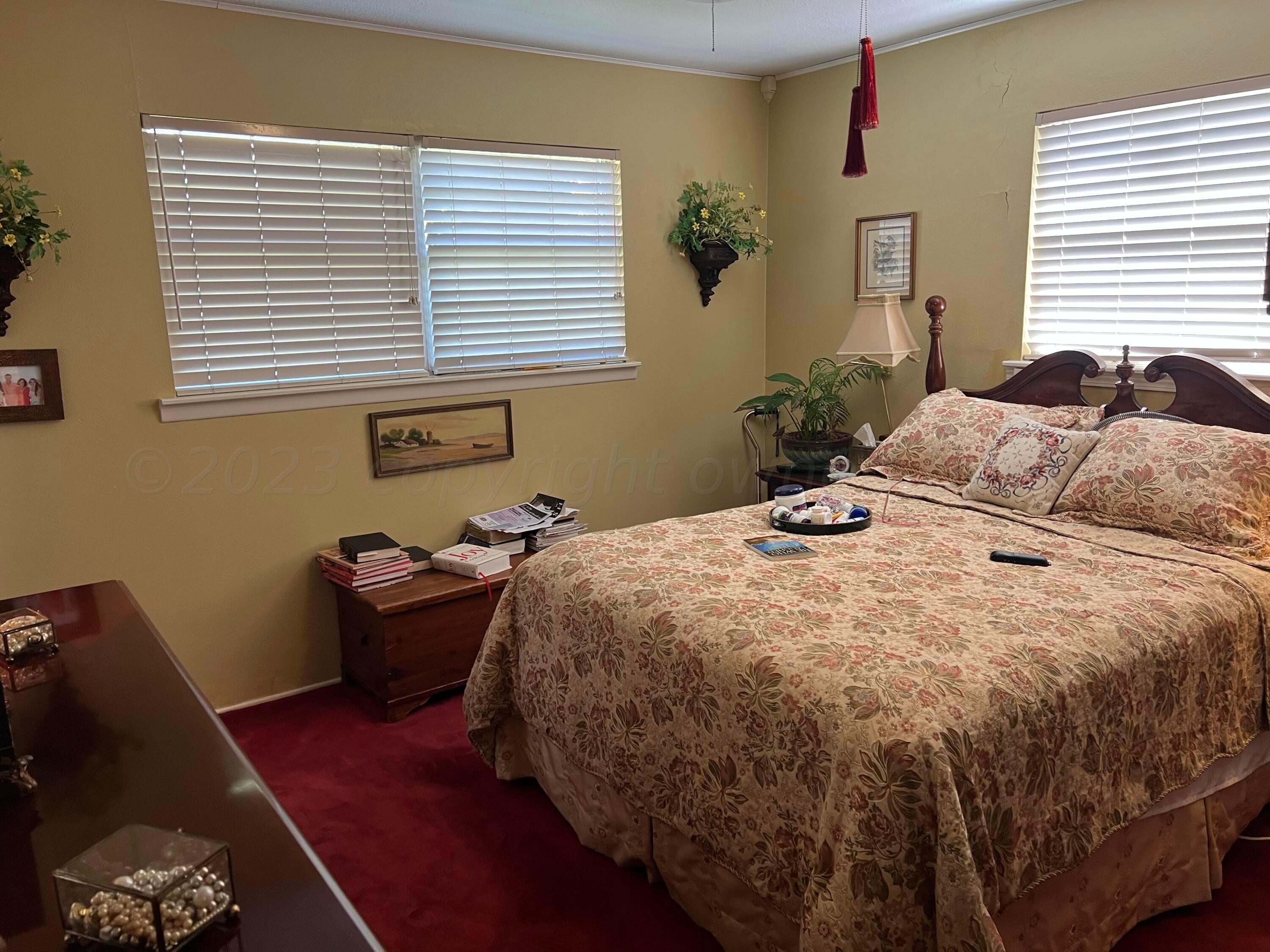 1505 Pellinore Street Borger, TX 79007 - Photo 43 of 73 a bedroom with a bed and wooden floor