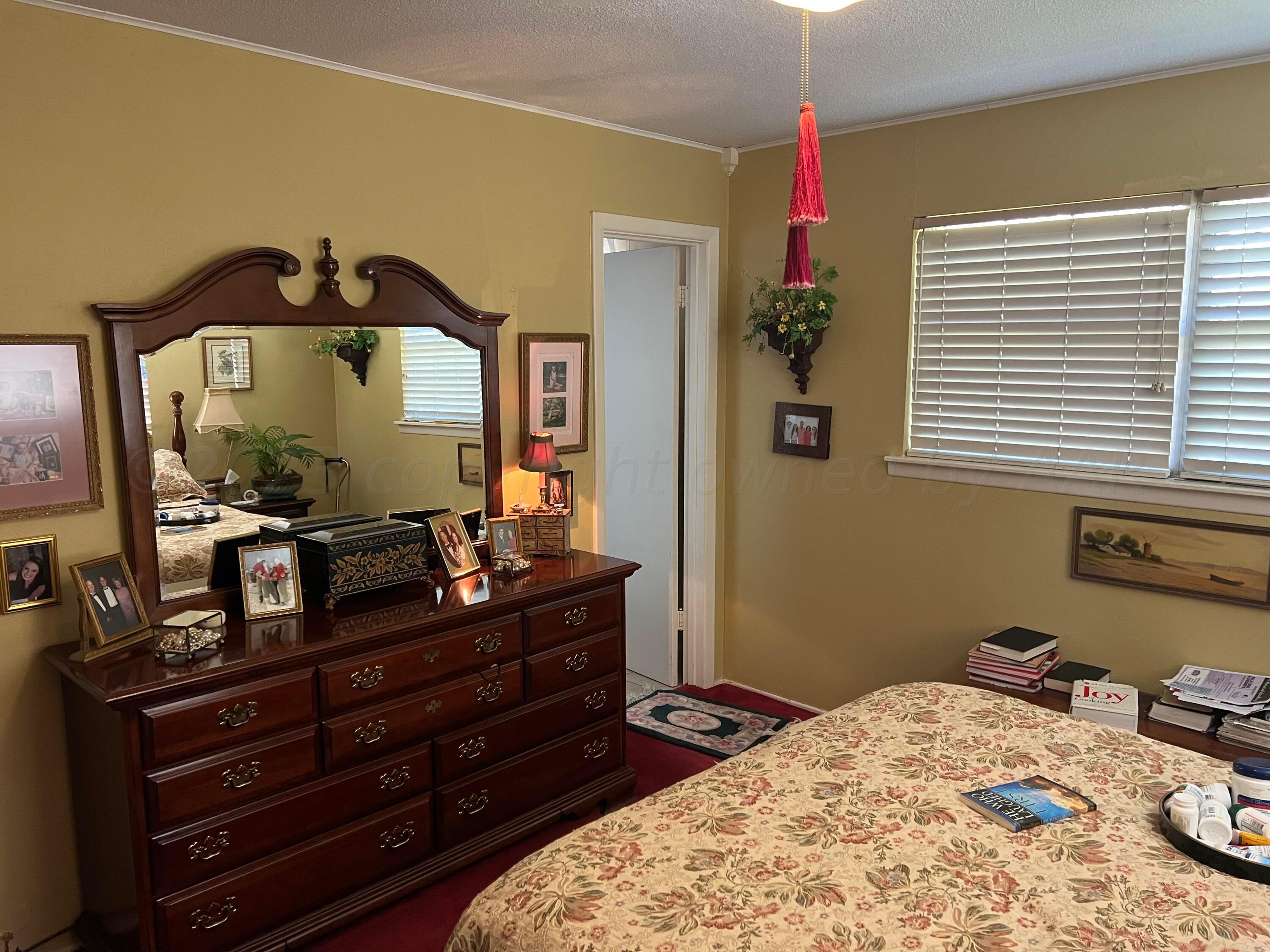 1505 Pellinore Street Borger, TX 79007 - Photo 44 of 73 a bedroom with a bed and a dresser