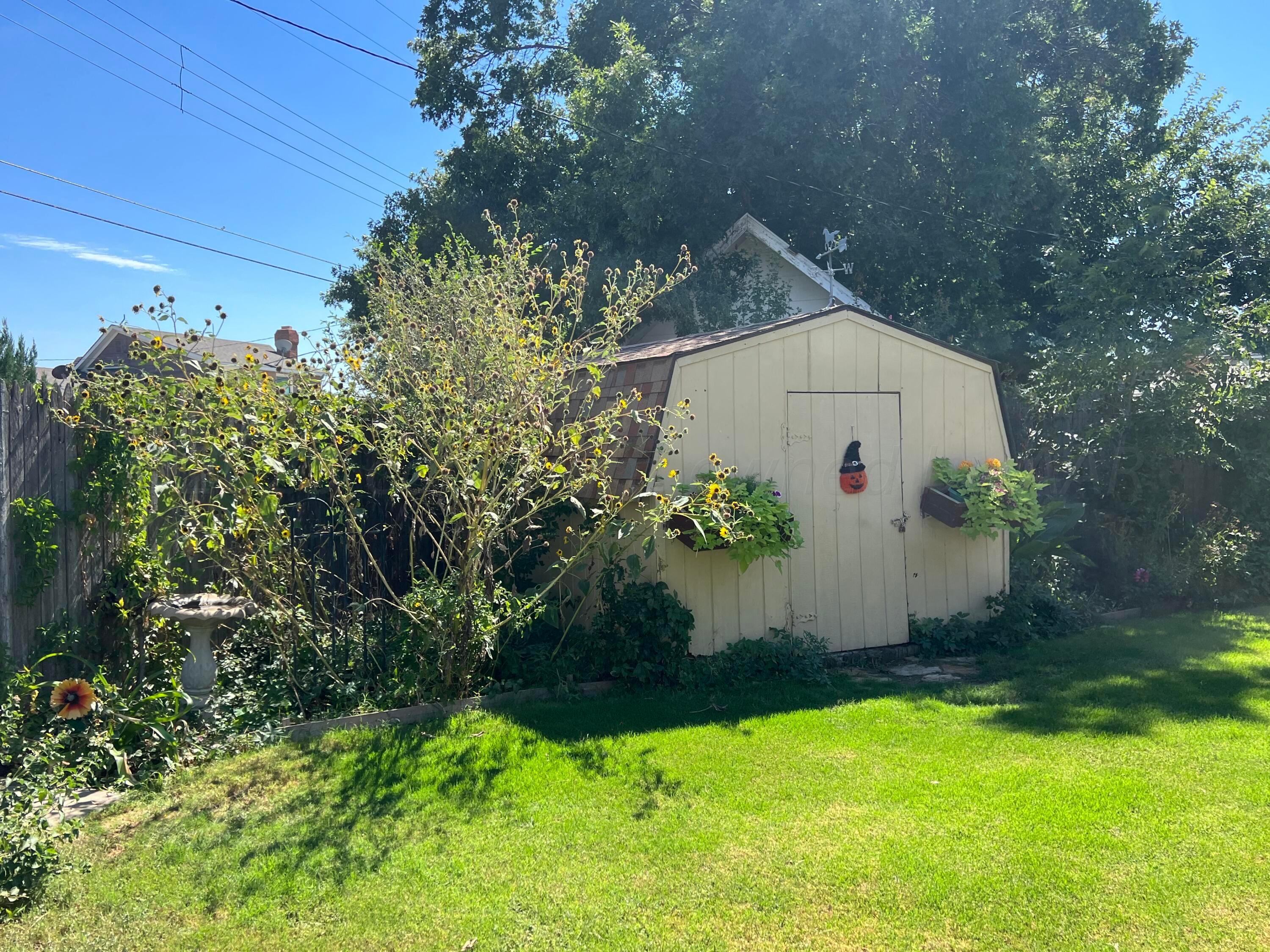 1505 Pellinore Street Borger, TX 79007 - Photo 56 of 73 a view of backyard with potted plants and wooden fence