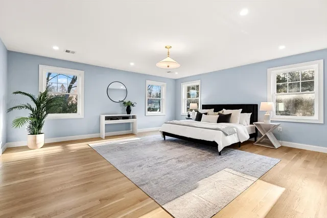 a bedroom with a large bed and a window