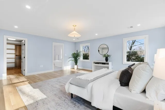 a bedroom with furniture and natural light