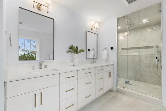 a bathroom with a shower sink and mirror