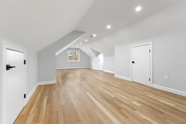 a living room with furniture a flat screen tv and paintings on the wall