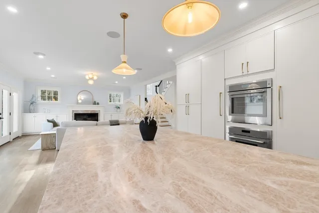 a view of a livingroom with furniture fireplace and a chandelier