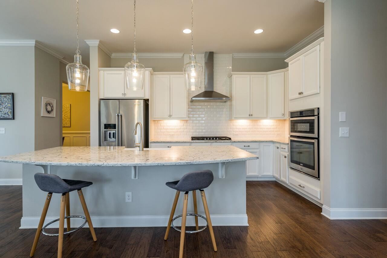 5264 Aleppo Lane Raleigh, NC 27613 - Photo 7 of 30 Modern range hood and built in oven and microwave make using this chef's kitchen a dream. Kitchen