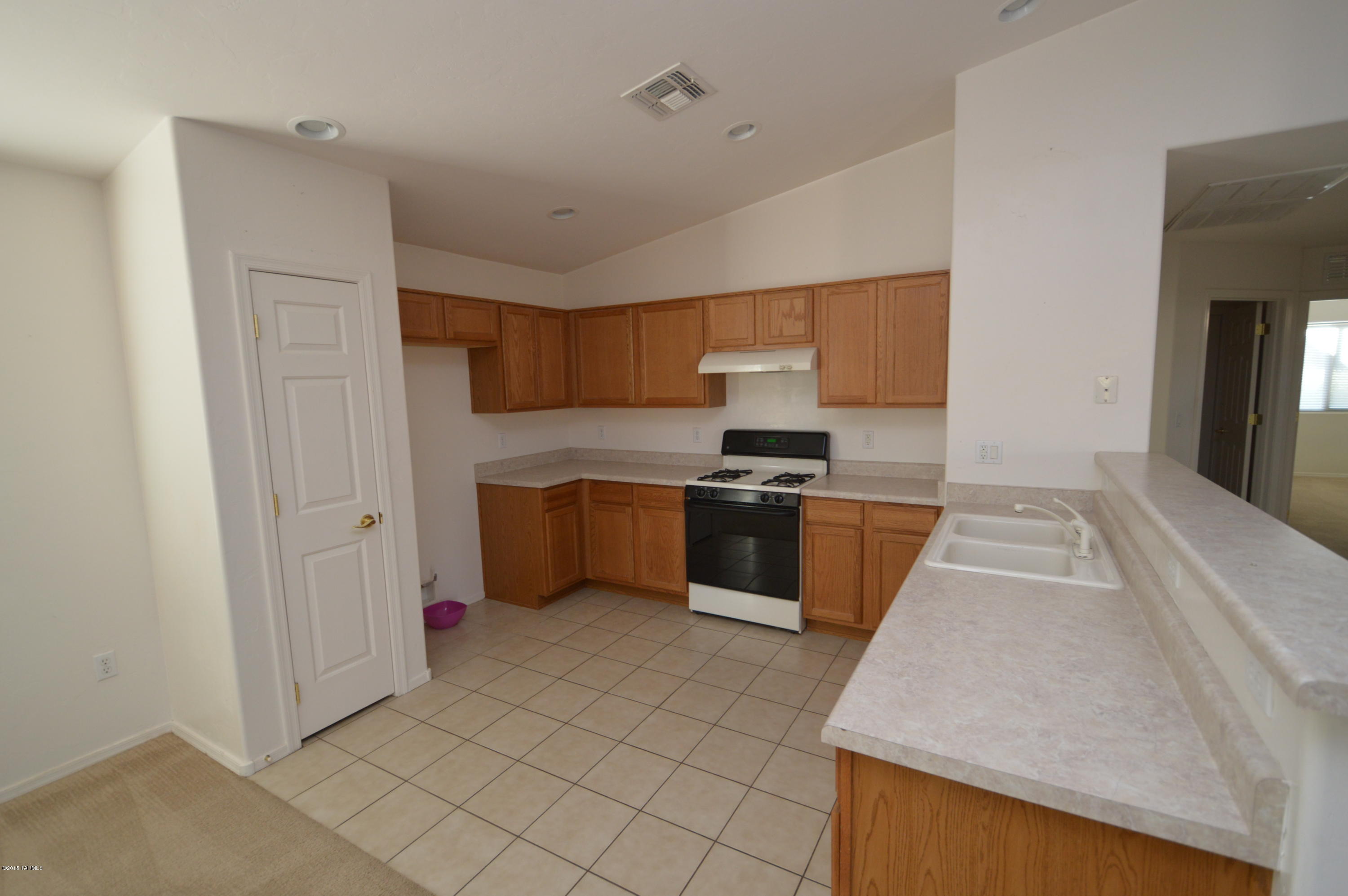 8396 West Benidorm Loop Tucson, AZ 85757 - Photo 5 of 13 a kitchen with a cabinets and white appliances