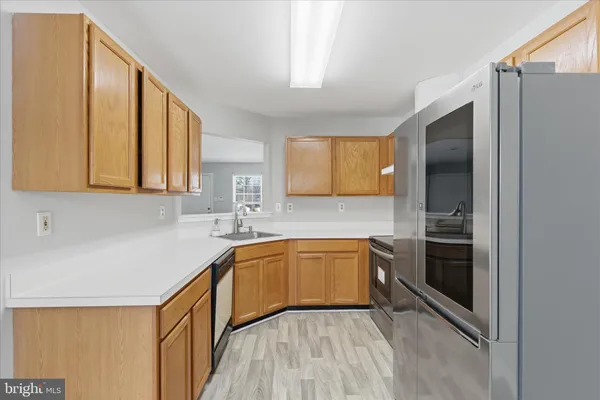 a kitchen with stainless steel appliances granite countertop a sink and a stove top oven