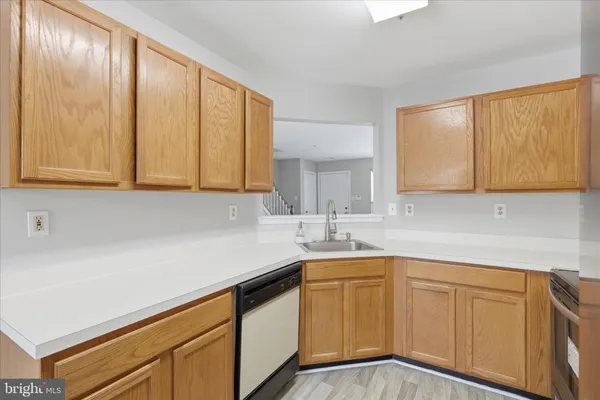 a kitchen with a sink cabinets and window