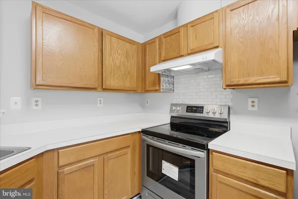 a kitchen with granite countertop cabinets stainless steel appliances and wooden cabinets