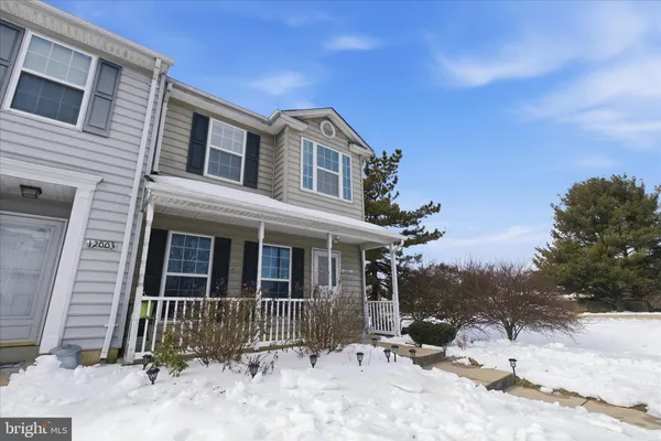 a backyard of a house with a tree