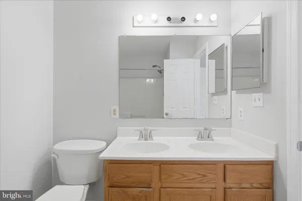 a bathroom with a sink double vanity and a mirror