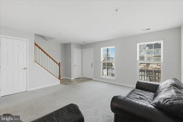 a living room with furniture and windows