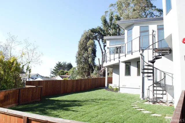 a view of house with backyard