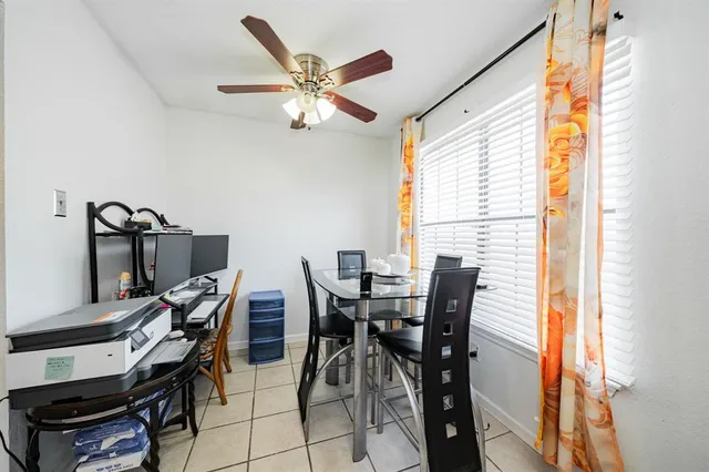 a view of a dining room with furniture and a window