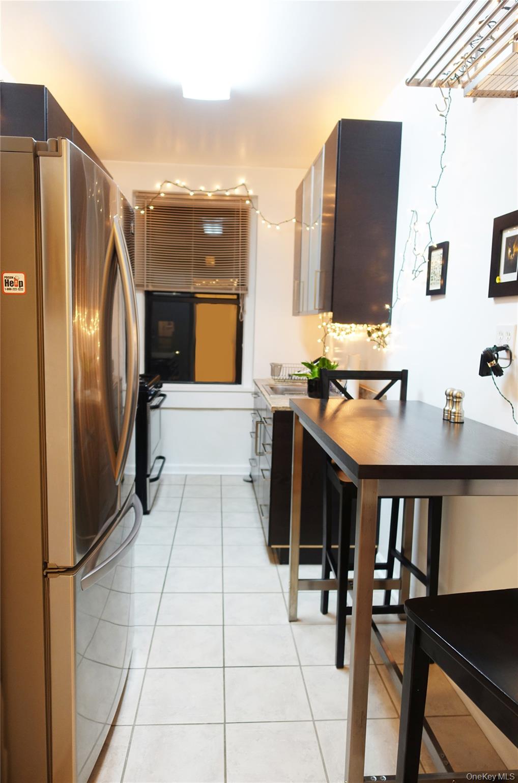 62-64 Saunders Street, Unit 4P Queens, NY 11374 - Photo 4 of 9 a kitchen with stainless steel appliances a stove refrigerator sink and cabinets