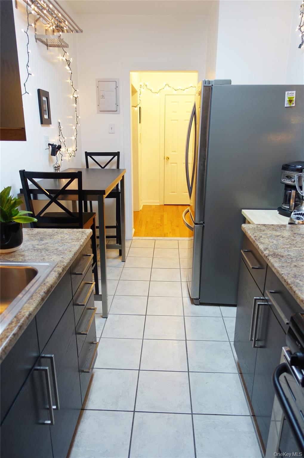 62-64 Saunders Street, Unit 4P Queens, NY 11374 - Photo 6 of 9 a kitchen with a sink a stove and a table