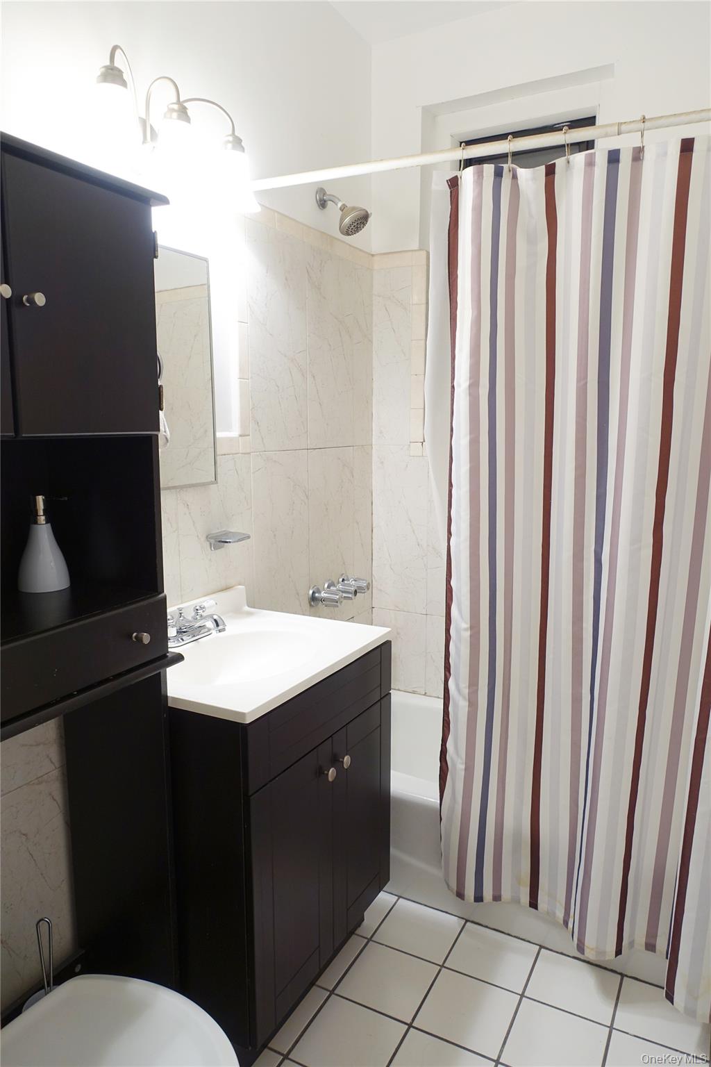 62-64 Saunders Street, Unit 4P Queens, NY 11374 - Photo 9 of 9 a bathroom with a sink and a mirror