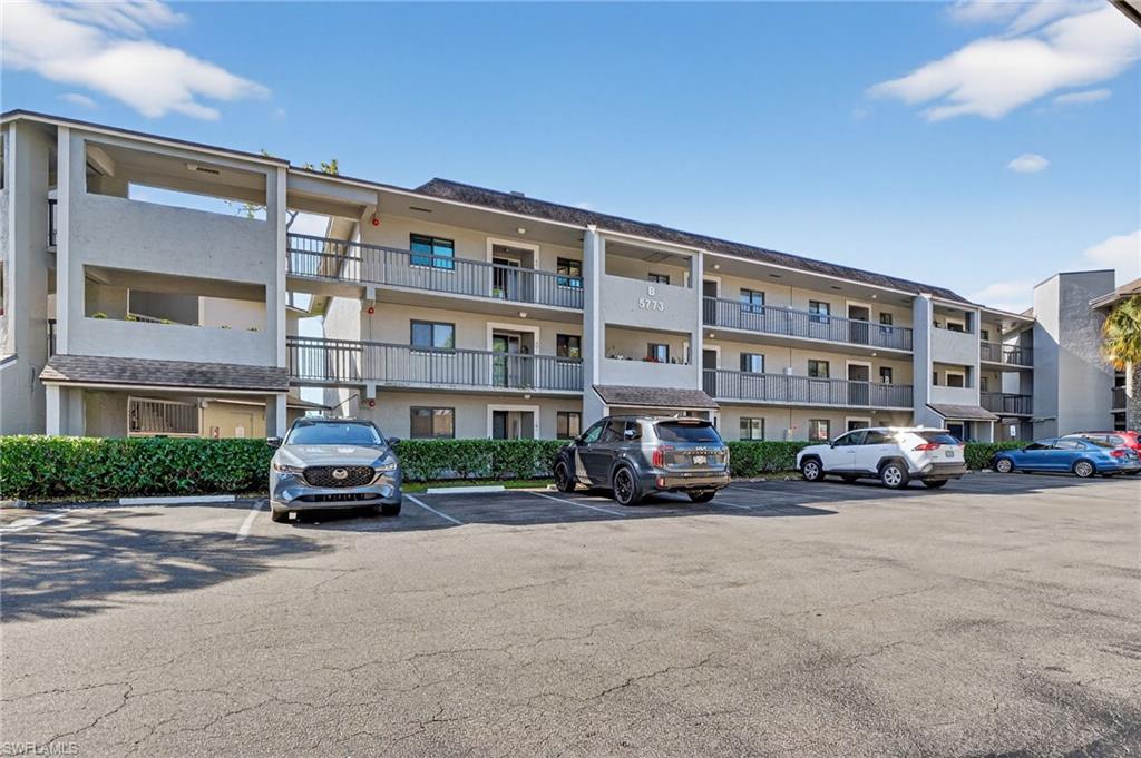 5773 Gage Lane, Unit B101 Naples, FL 34113 - Photo 2 of 39 a car parked in front of a building