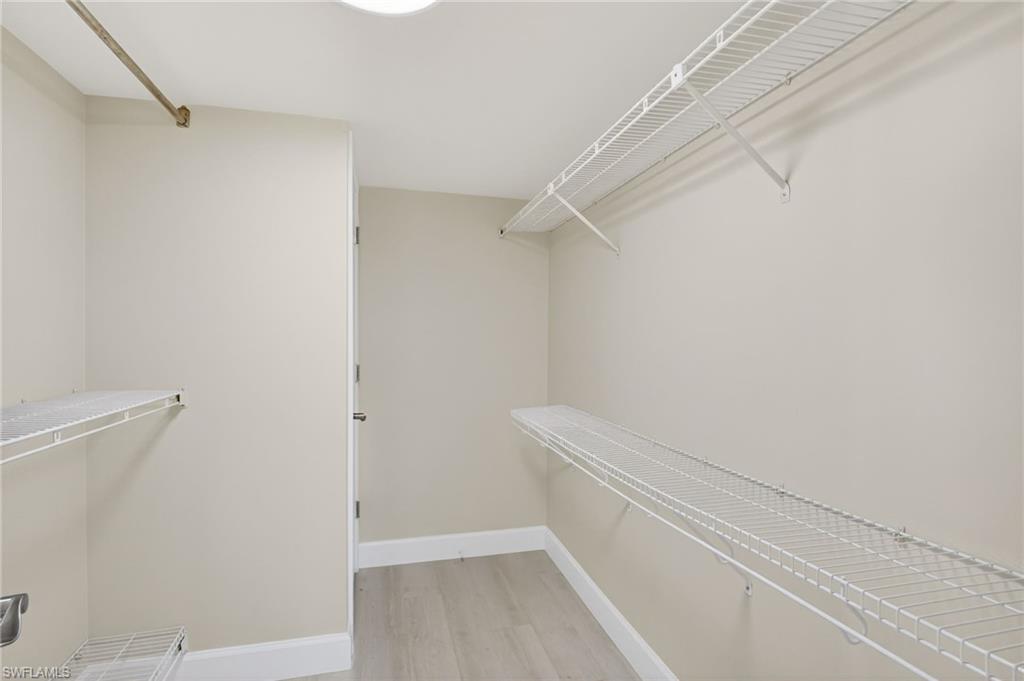 5773 Gage Lane, Unit B101 Naples, FL 34113 - Photo 22 of 39 a view of walk in closet with empty racks
