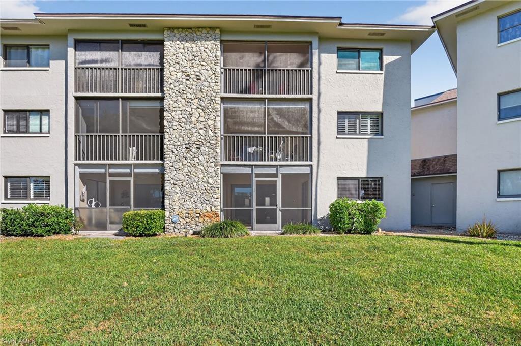 5773 Gage Lane, Unit B101 Naples, FL 34113 - Photo 26 of 39 a front view of a house with garden