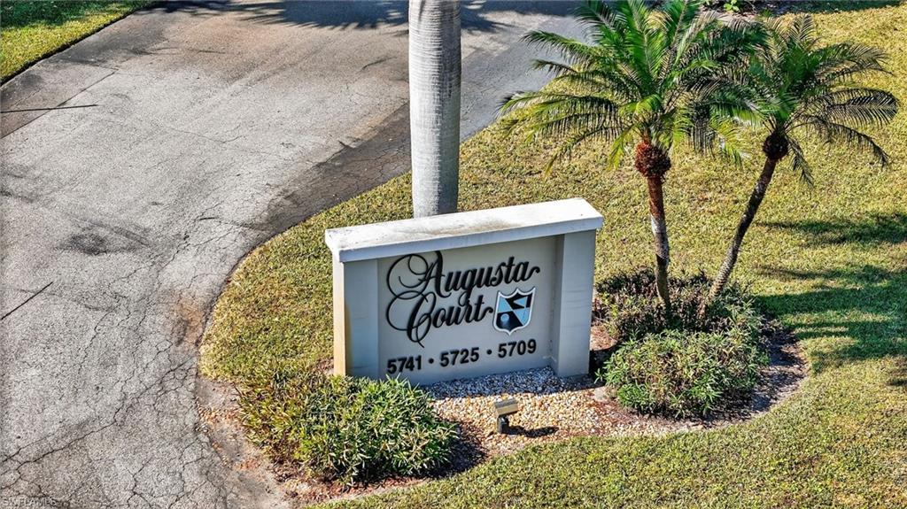 5773 Gage Lane, Unit B101 Naples, FL 34113 - Photo 31 of 39 a sign on the side of a building