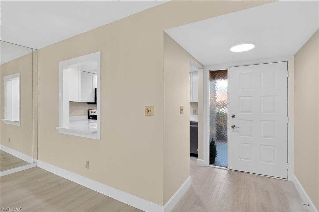 5773 Gage Lane, Unit B101 Naples, FL 34113 - Photo 4 of 39 wooden floor in an empty room