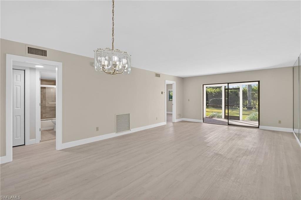 5773 Gage Lane, Unit B101 Naples, FL 34113 - Photo 6 of 39 a view of an empty room with window and chandelier fan
