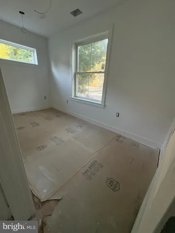 a living room with stainless steel appliances kitchen island granite countertop a refrigerator and a sink