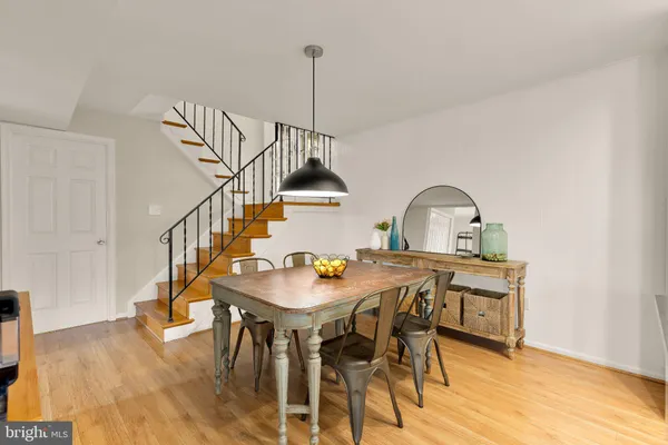 a dining room with furniture window and wooden floor