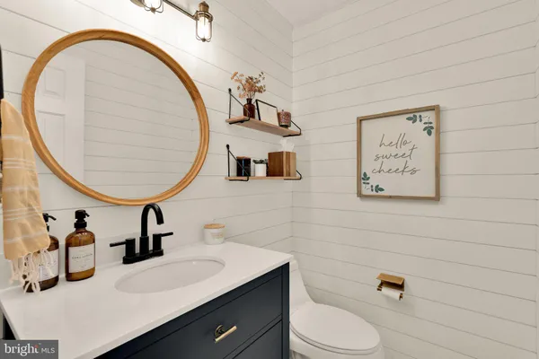 a bathroom with a sink mirror and toilet