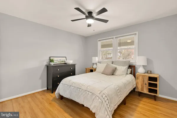 a bedroom with a bed and a ceiling fan